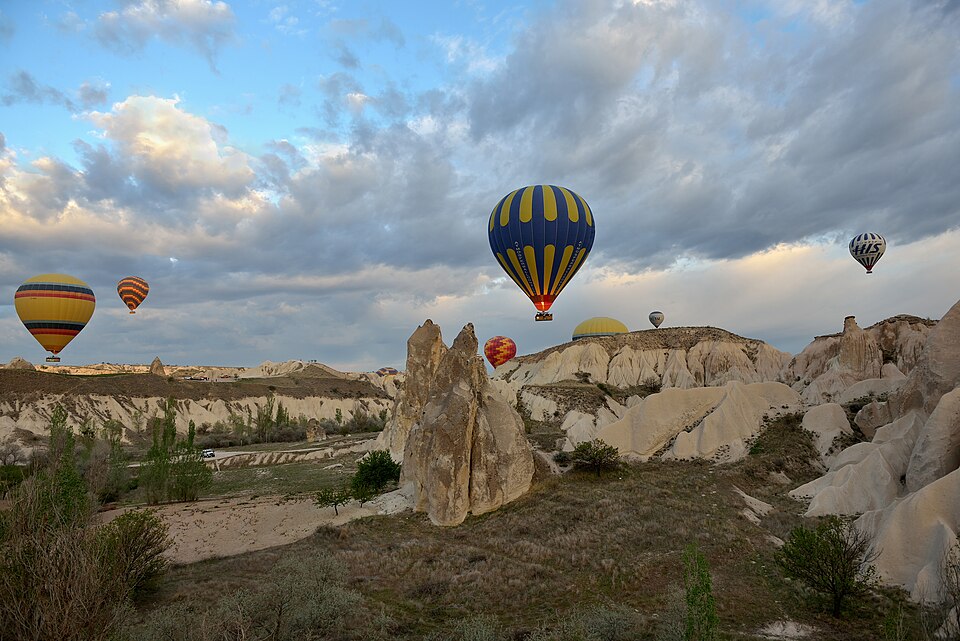 Hot air balloons over the valleys of Cappadocia, Türkiye at sunrise